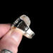 holding bottom side view, cushion black onyx gemstone bezel set bead wire and stamped cutout wire accent on tapered wide band